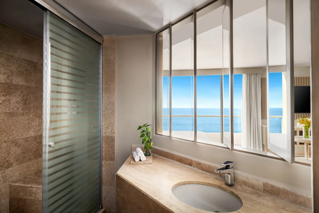 Sun Club Honeymoon Suite bathroom vanity with marble countertop and ocean view at Sunscape Dorado Pacifico Ixtapa.
