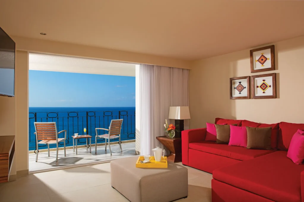 Deluxe Junior Suite Ocean Front View living area with private balcony and ocean views at Sunscape Puerto Vallarta Resort & Spa.