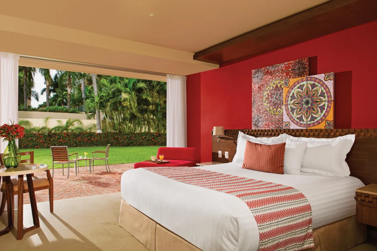 Deluxe Resort View room with king bed and private balcony overlooking the gardens at Sunscape Puerto Vallarta Resort & Spa.