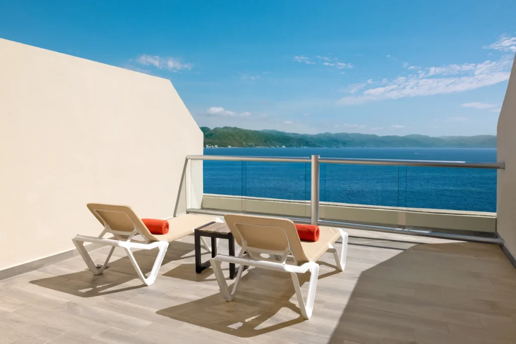 Sun Club Romantic Ocean Front terrace with loungers and panoramic ocean views at Sunscape Puerto Vallarta Resort & Spa.