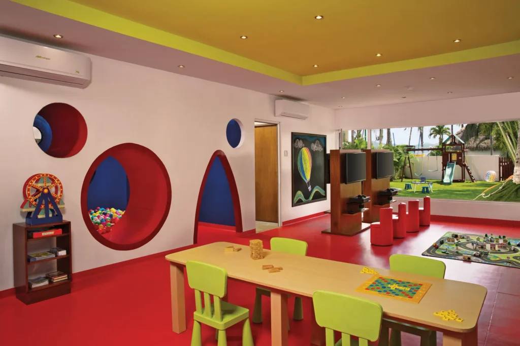 Kids enjoying games and activities inside the Explorer’s Club at Sunscape Puerto Vallarta Resort & Spa, a colorful supervised play space for children.