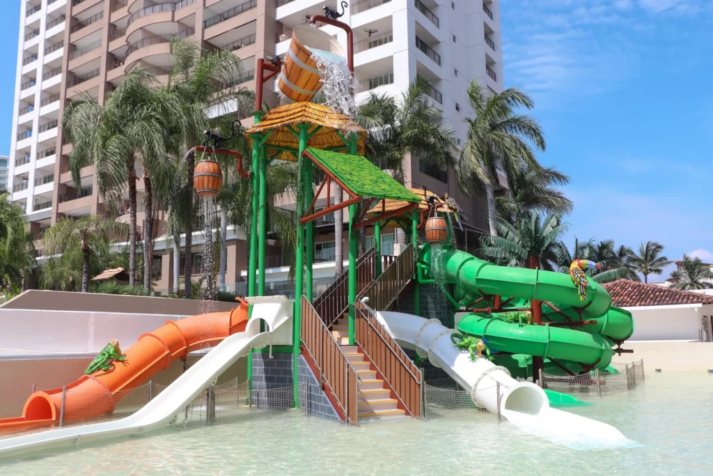 Colorful water slides and tipping bucket at Sunny’s Splash Park at Sunscape Puerto Vallarta Resort & Spa, designed for kids’ water fun.