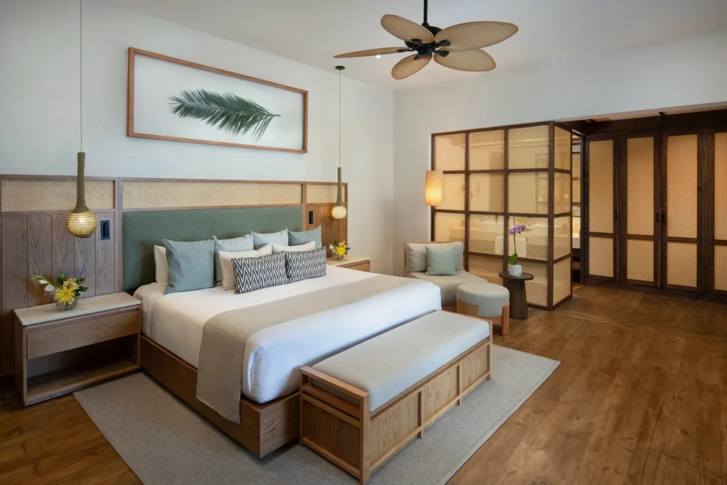 Junior Suite Deluxe Oceanfront king bedroom at Zoëtry Agua Punta Cana with private terrace access.