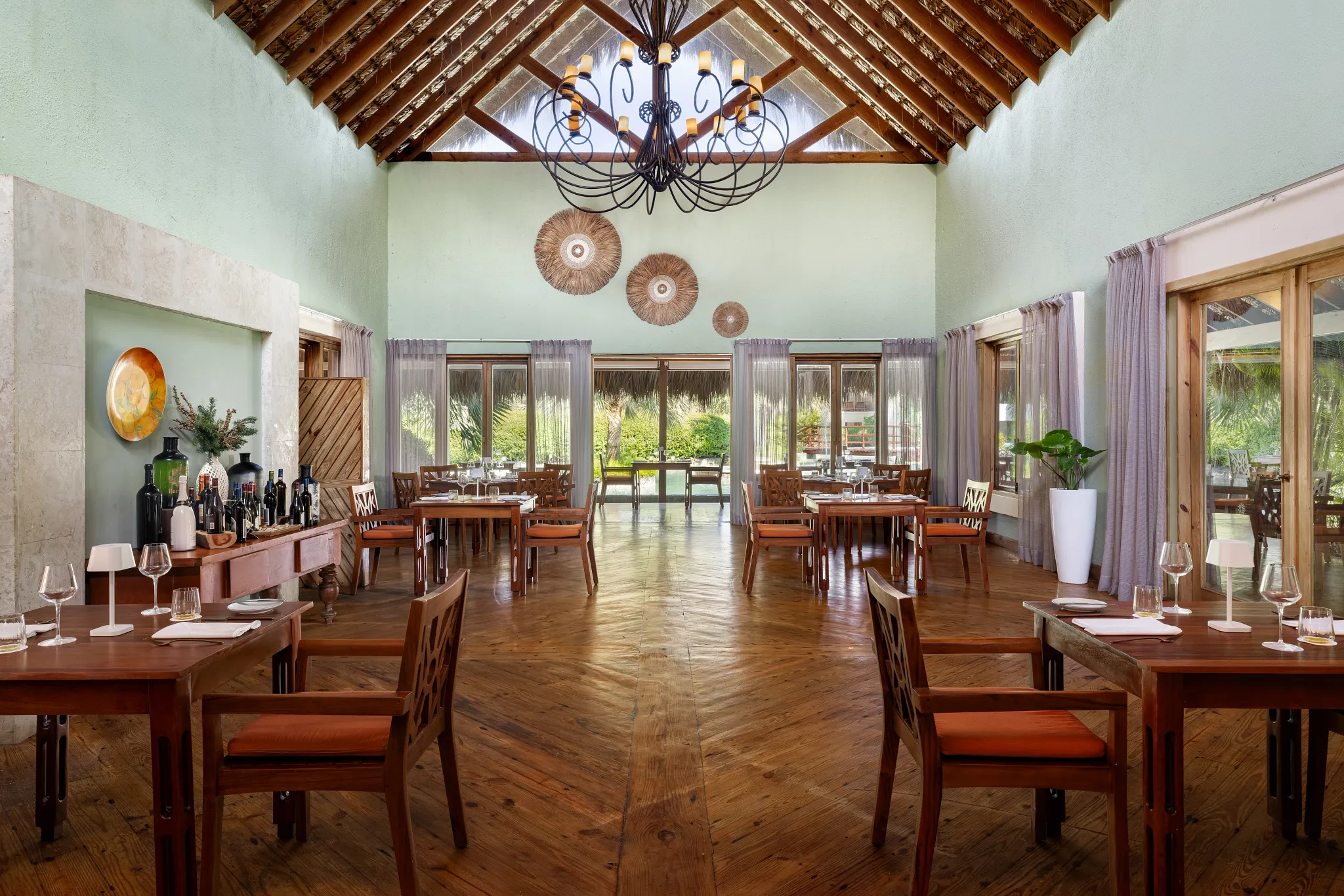 Amaya Restaurant at Zoëtry Agua Punta Cana featuring elegant wooden interiors, vaulted ceilings, and intimate fine dining ambiance.