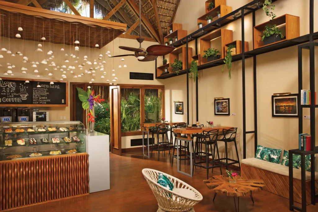 Coco Café at Zoëtry Agua Punta Cana featuring a cozy coffee bar, gourmet pastries display, and modern tropical décor.