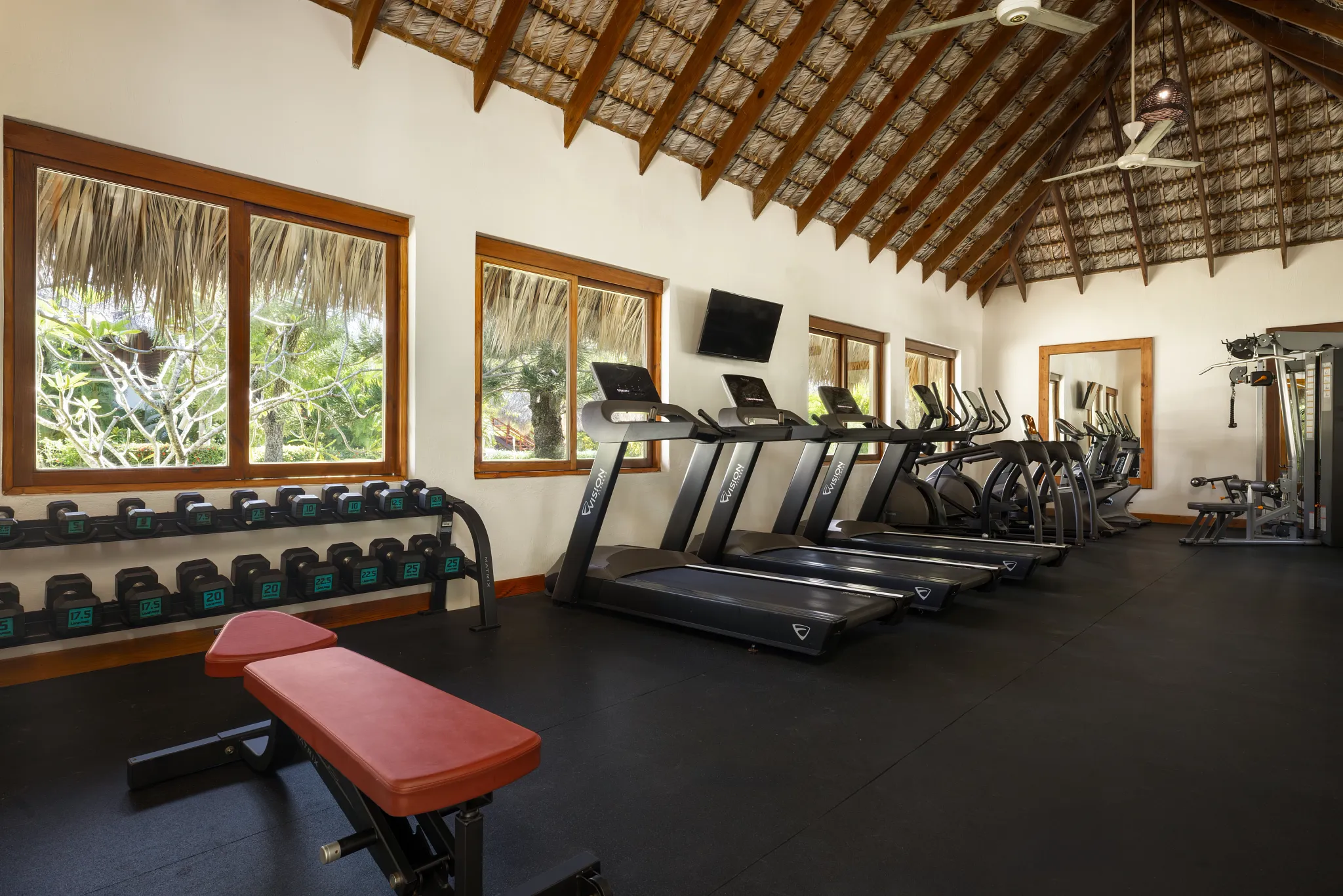 Modern fitness center with treadmills and free weights at Zoëtry Agua Punta Cana.