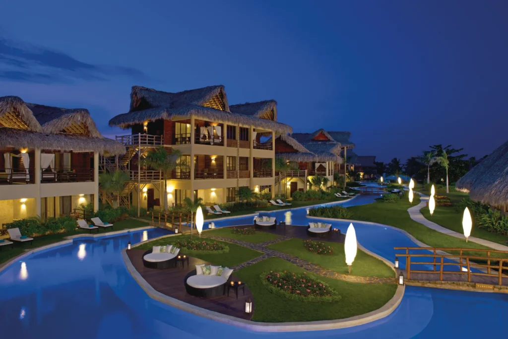 Nighttime panoramic view of illuminated lagoon pools at Zoëtry Agua Punta Cana.