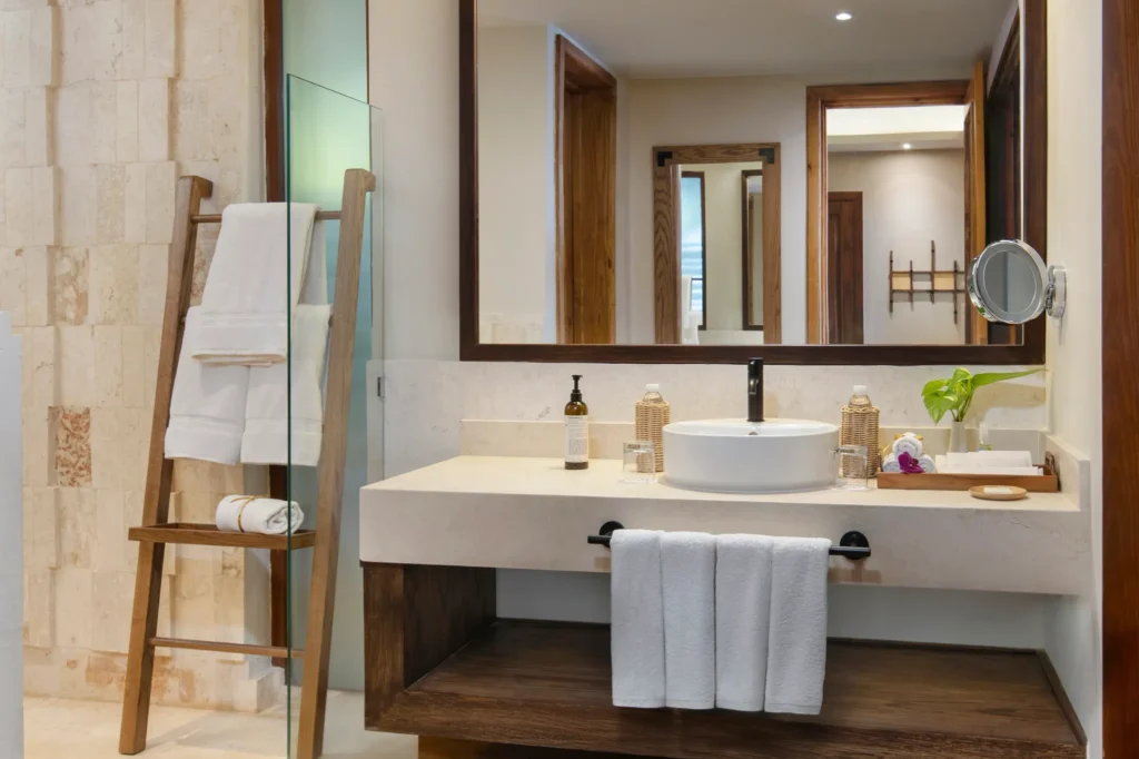 Villa Caney Garden View bathroom with stone vanity, vessel sink, and walk-in shower at Zoëtry Agua Punta Cana.