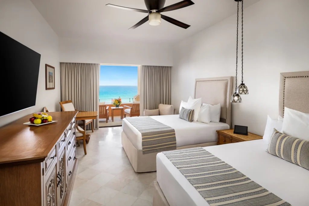 Junior Suite Oceanfront with two double beds and balcony view at Zoëtry Casa del Mar Los Cabos.