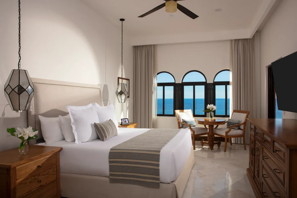 One Bedroom Suite oceanfront bedroom with king bed and seating area at Zoëtry Casa del Mar Los Cabos.
