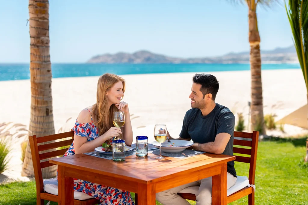 Couple enjoying outdoor dining with ocean views at Zoëtry Casa del Mar Los Cabos.