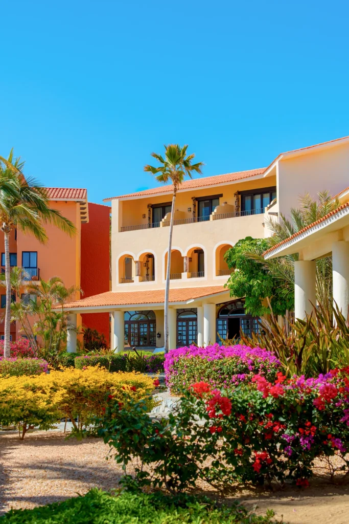 Colorful hacienda-style buildings surrounded by tropical gardens at Zoëtry Casa del Mar Los Cabos.