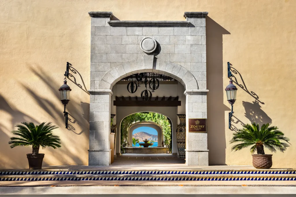 Grand stone archway entrance with ocean view at Zoëtry Casa del Mar Los Cabos.