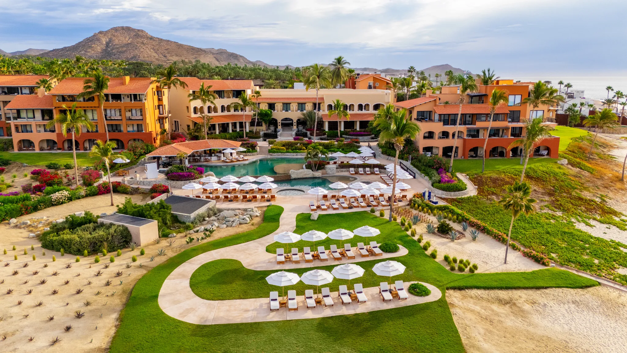 Aerial view of Zoëtry Casa del Mar Los Cabos with pool, beachfront, and terracotta buildings along the Sea of Cortez.