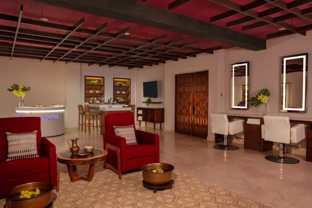 Elegant spa lounge with red seating and Natura Bissé products at Zoëtry Casa del Mar Los Cabos.
