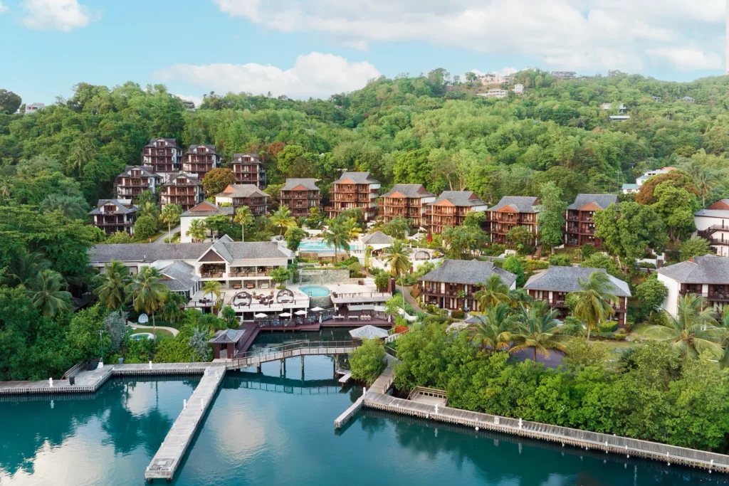 Aerial perspective of Zoëtry Marigot Bay St. Lucia with marina docks, boardwalk, and hillside accommodations.