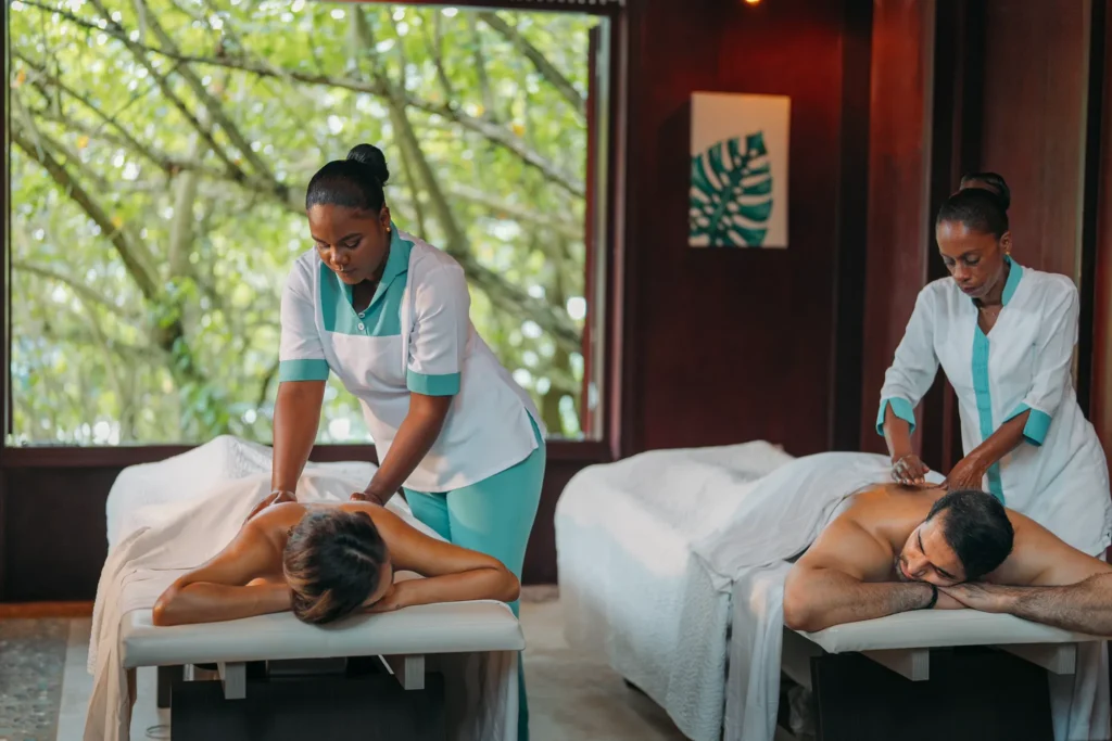 Couple enjoying a relaxing side-by-side massage at Zoëtry Marigot Bay St. Lucia spa surrounded by tropical views.