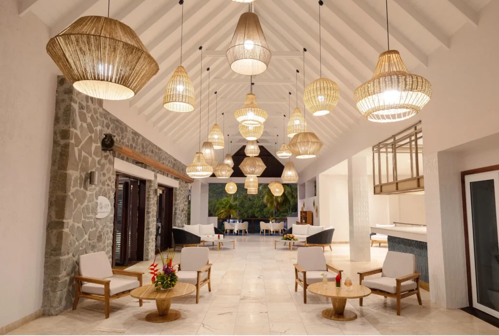 Elegant open-air lobby at Zoëtry Marigot Bay St. Lucia featuring woven pendant lights and natural stone accents.