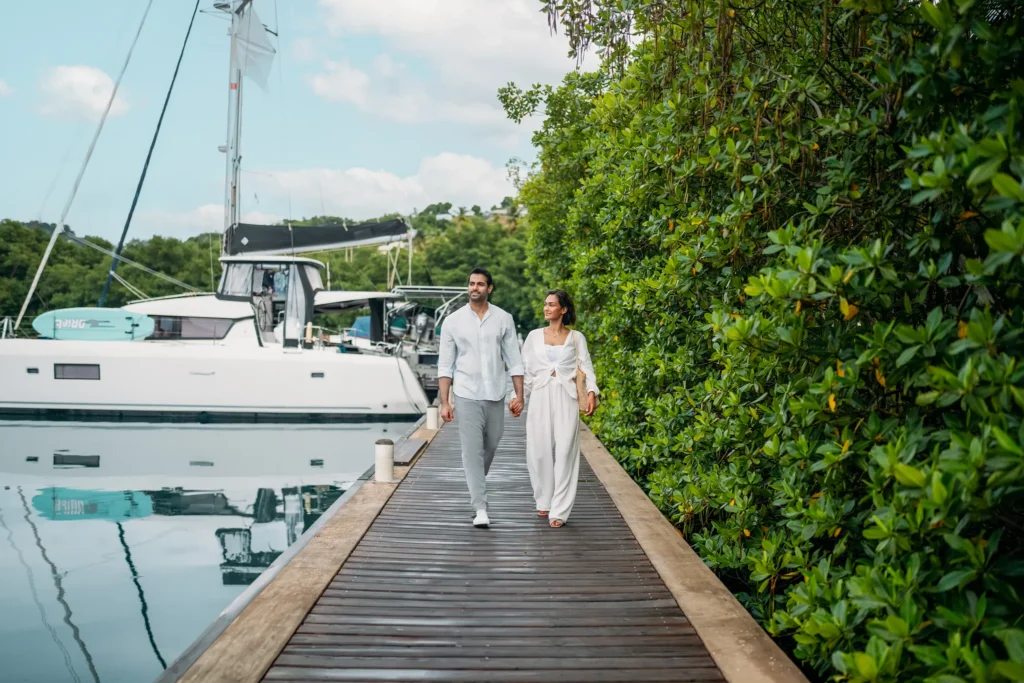 Stylish couple enjoying a scenic waterfront walk at Zoëtry Marigot Bay St. Lucia.