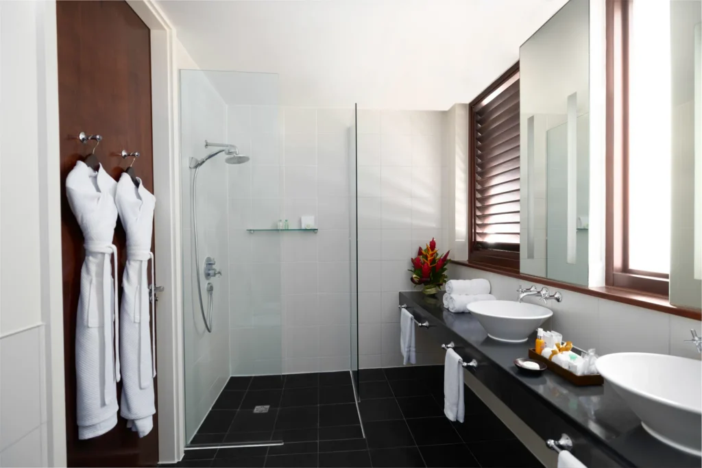Bathroom with double vanities and walk-in rain shower in Master Suite Two Bedroom Residence at Zoëtry Marigot Bay.
