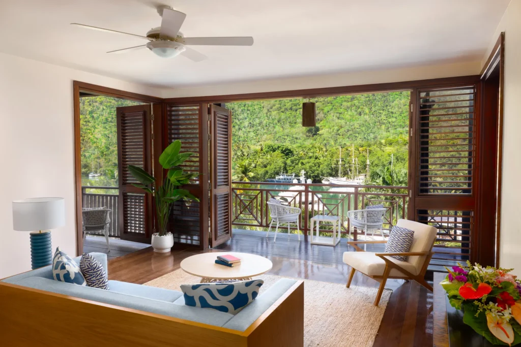 Living room with open balcony and bay views in Master Suite Two Bedroom Residence with Plunge Pool at Zoëtry Marigot Bay.