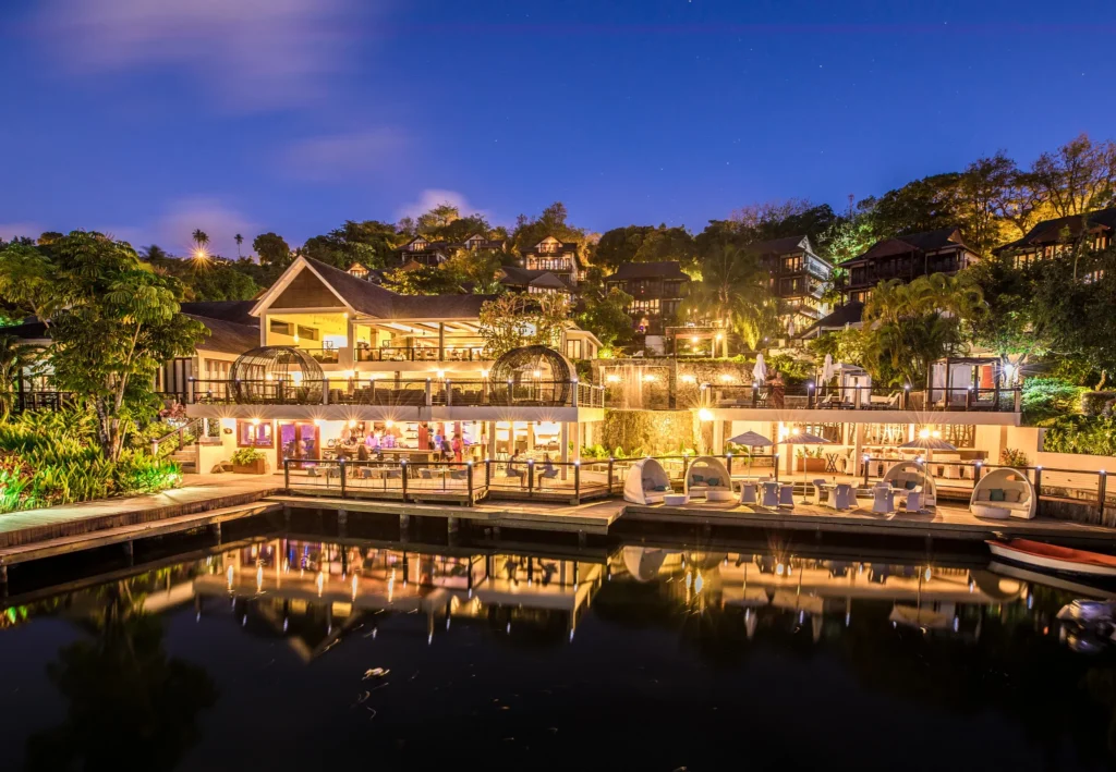 Zoëtry Marigot Bay St. Lucia illuminated at night with marina reflections and tropical landscaping.