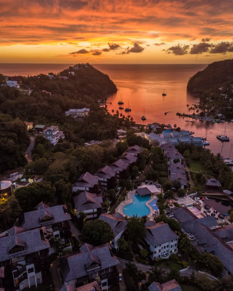 Aerial sunset view of Zoëtry Marigot Bay St. Lucia overlooking the Caribbean Sea and marina entrance.