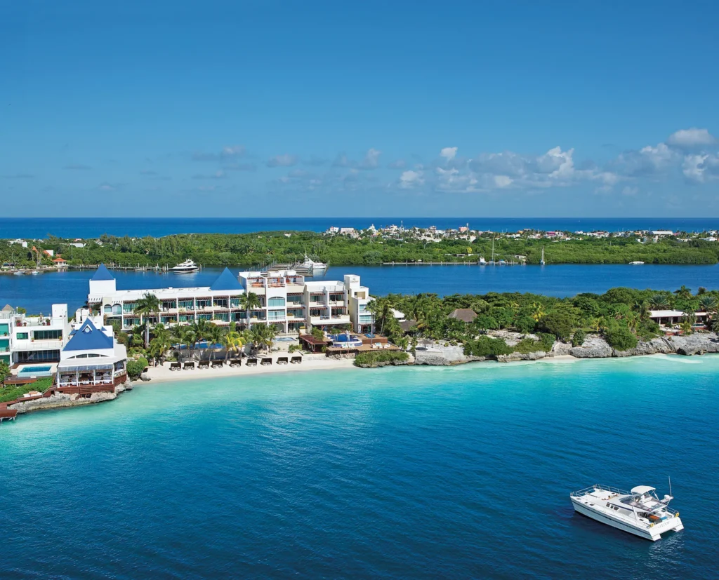 Aerial view of Zoëtry Villa Rolandi Isla Mujeres beachfront resort with turquoise waters and private shoreline.