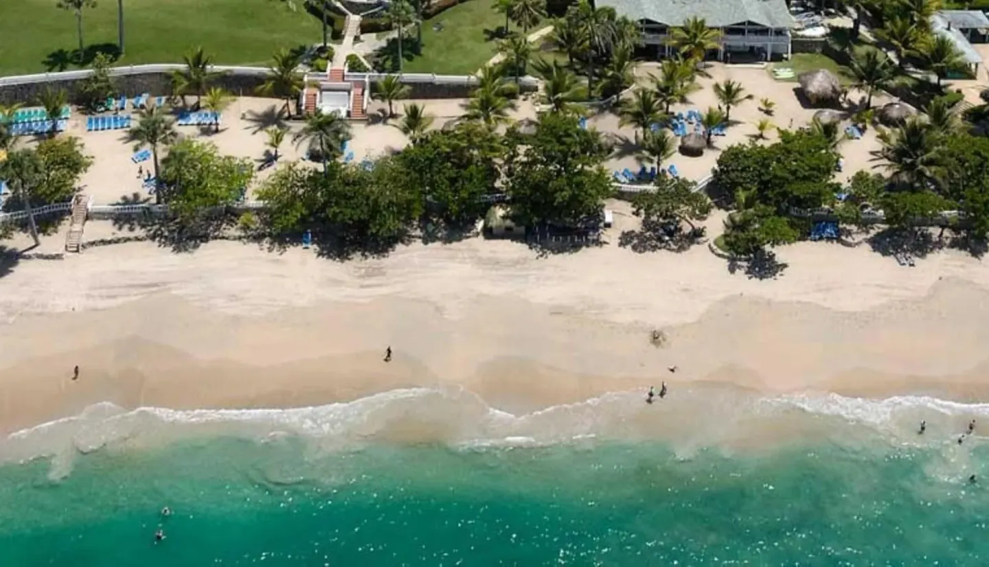 Aerial beach view with palms and turquoise water at Lifestyle Tropical Beach Resort & Spa.