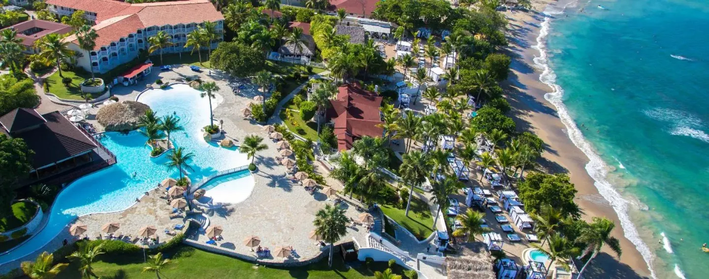 Aerial view of pools, palms, beach, and ocean at Lifestyle Tropical Beach Resort & Spa.