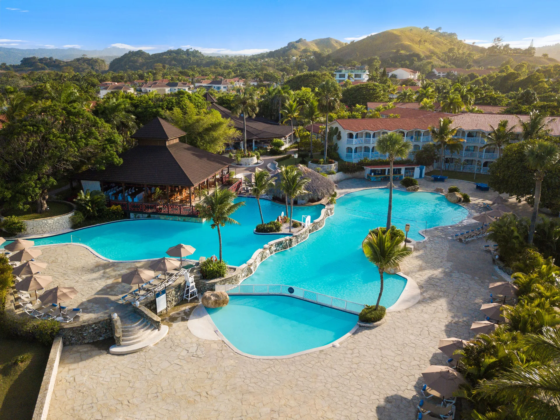 Aerial view of pools, palms and resort buildings at Lifestyle Tropical Beach Resort & Spa.