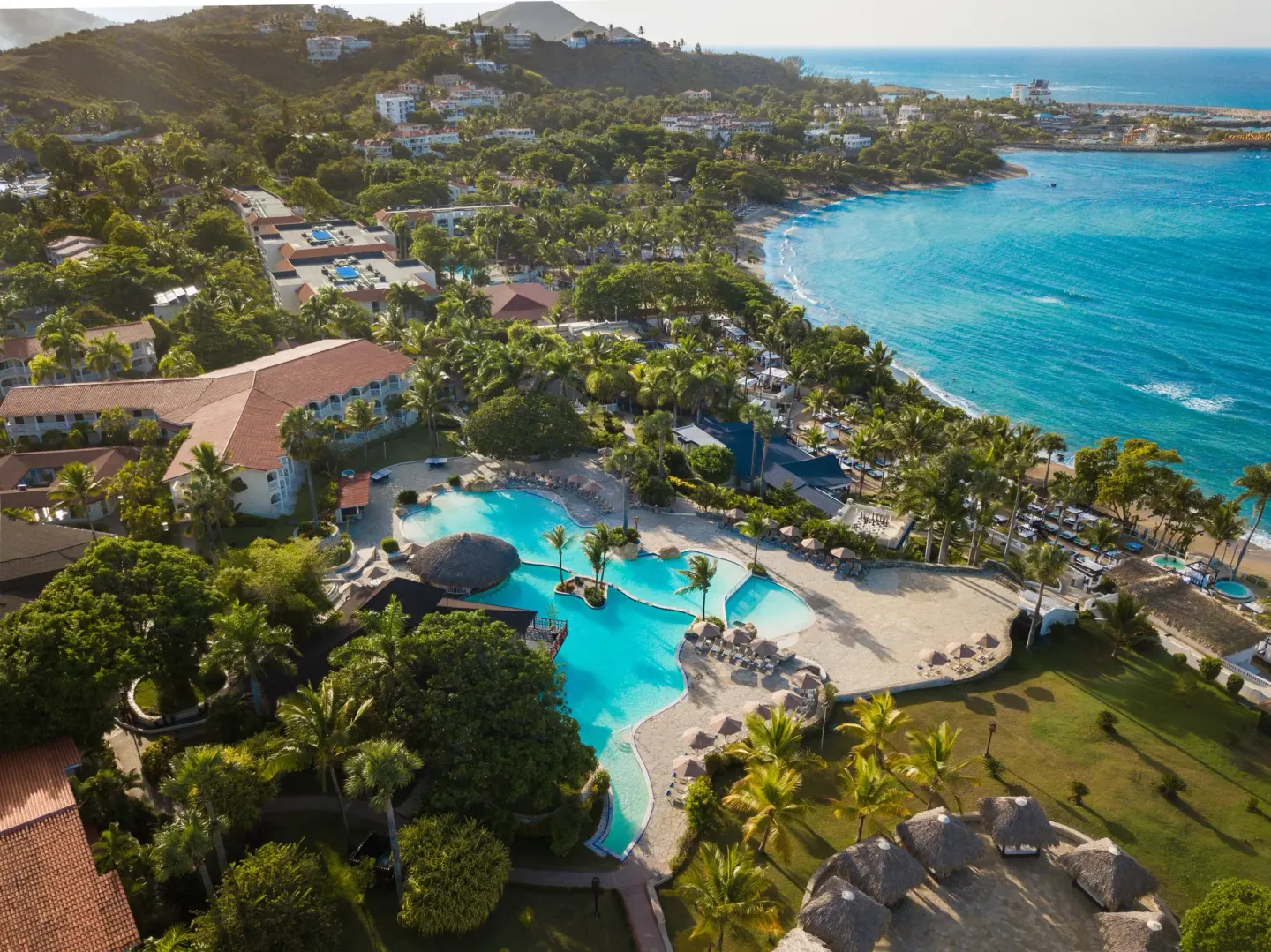 Aerial view of pools, palms, and coastline at Lifestyle Tropical Beach Resort & Spa.