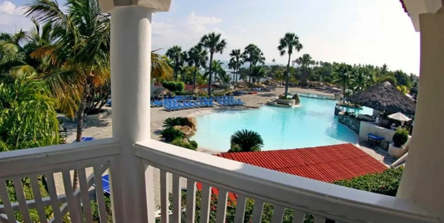Balcony view over pool, palms, and lounge chairs at Lifestyle Tropical Beach Resort & Spa.