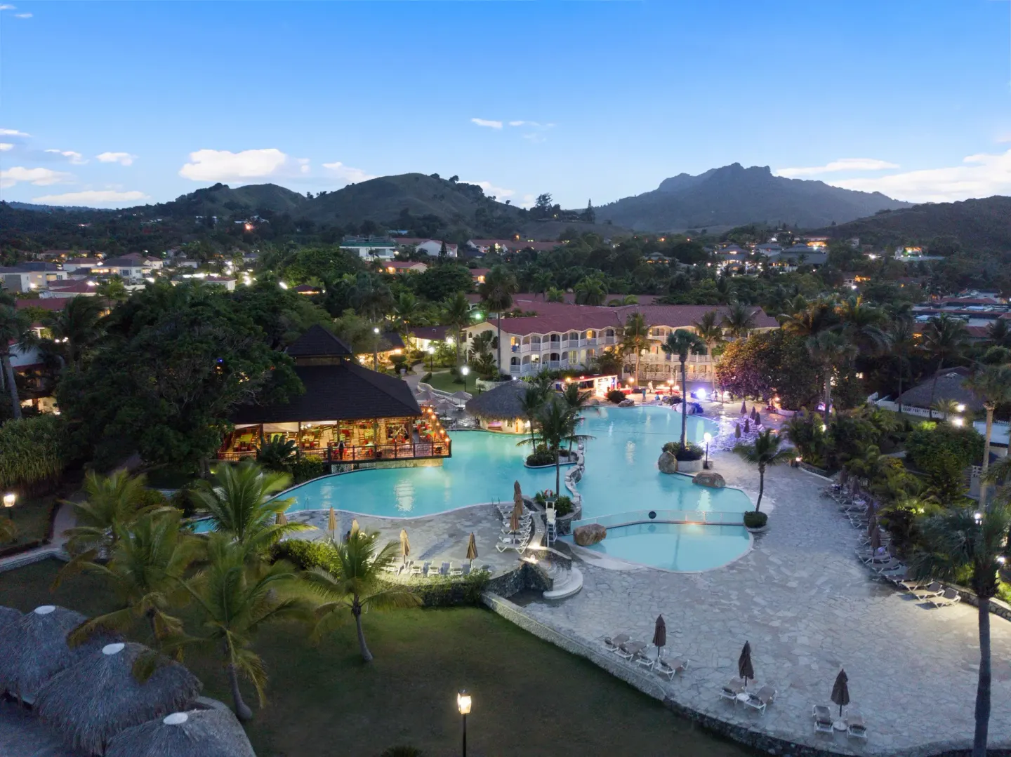 Evening aerial view of illuminated pools at Lifestyle Tropical Beach Resort & Spa.