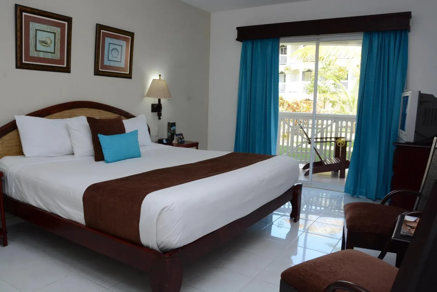 Guest room with king bed and balcony at Lifestyle Tropical Beach Resort & Spa.