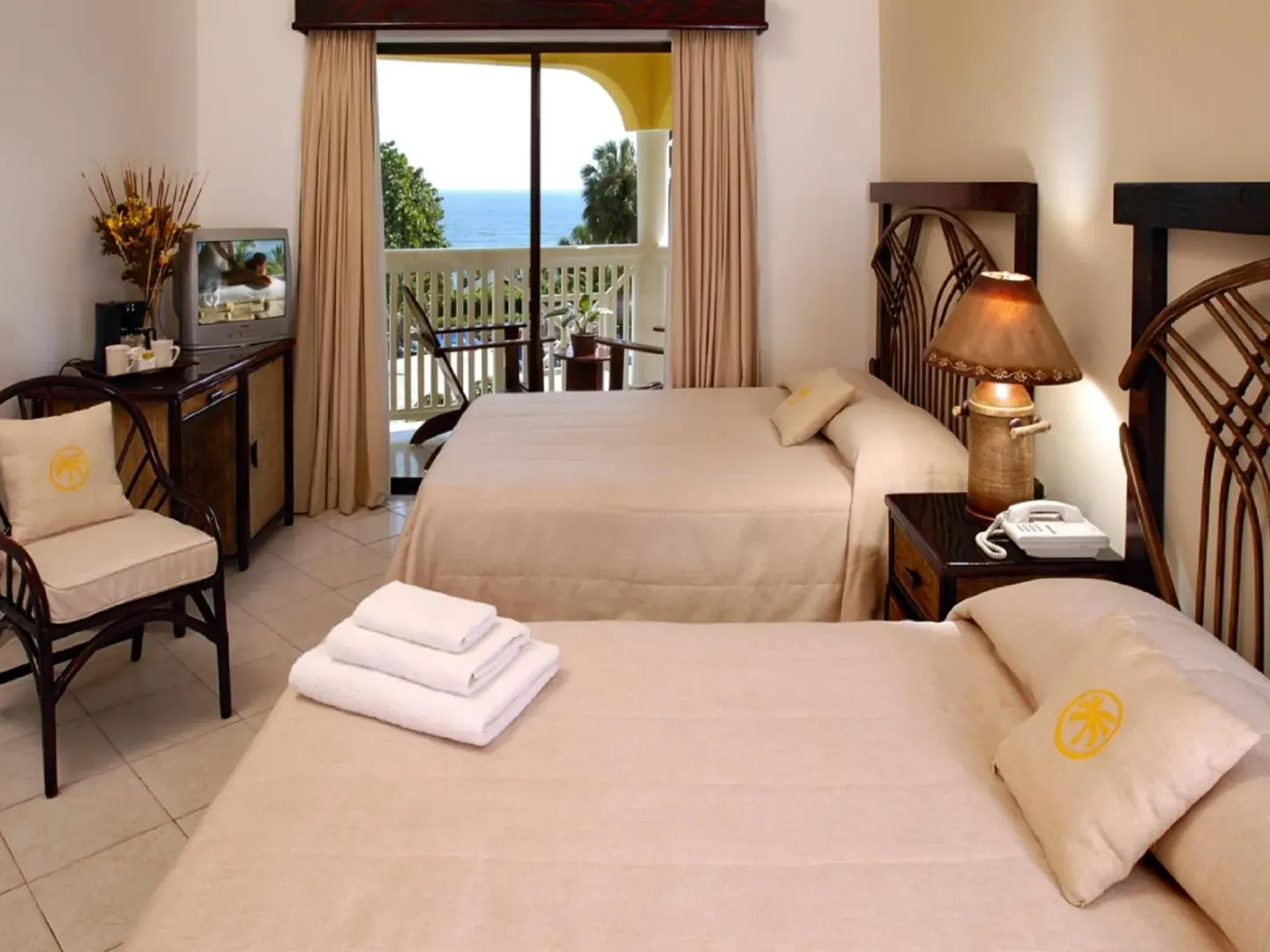 Guest room with two beds and balcony ocean view at Lifestyle Tropical Beach Resort & Spa.