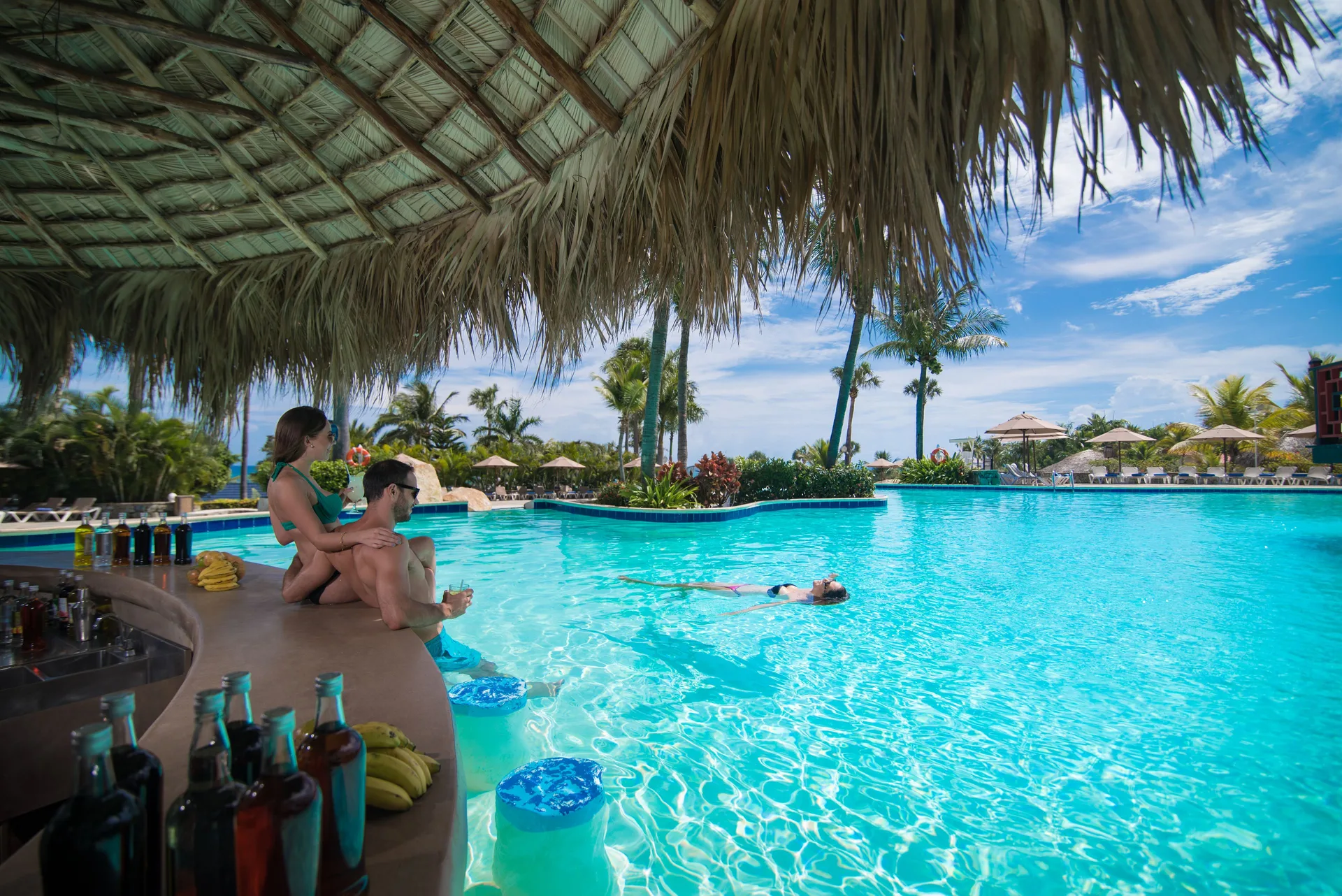 Guests relax at a swim-up pool bar at Lifestyle Tropical Beach Resort & Spa.