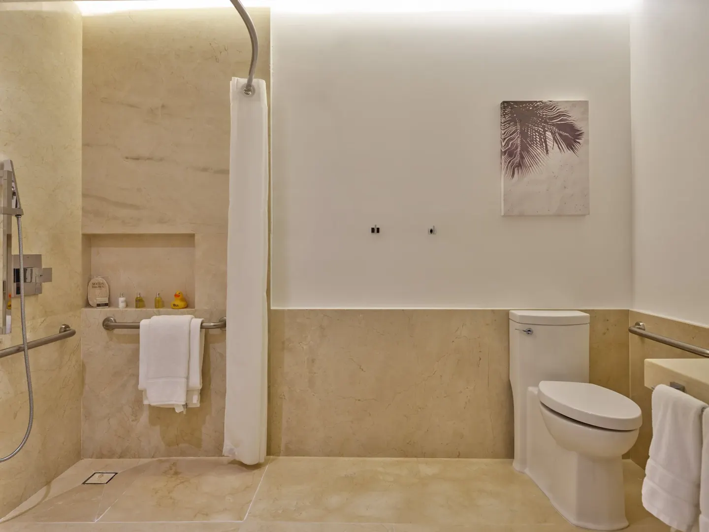 Accessible shower and toilet in a guest bathroom at Live Aqua Cancun.