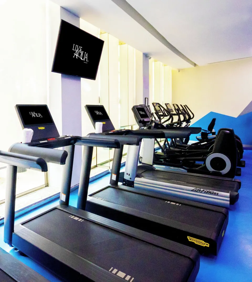 Fitness room with treadmills and cardio machines at Live Aqua Cancun.