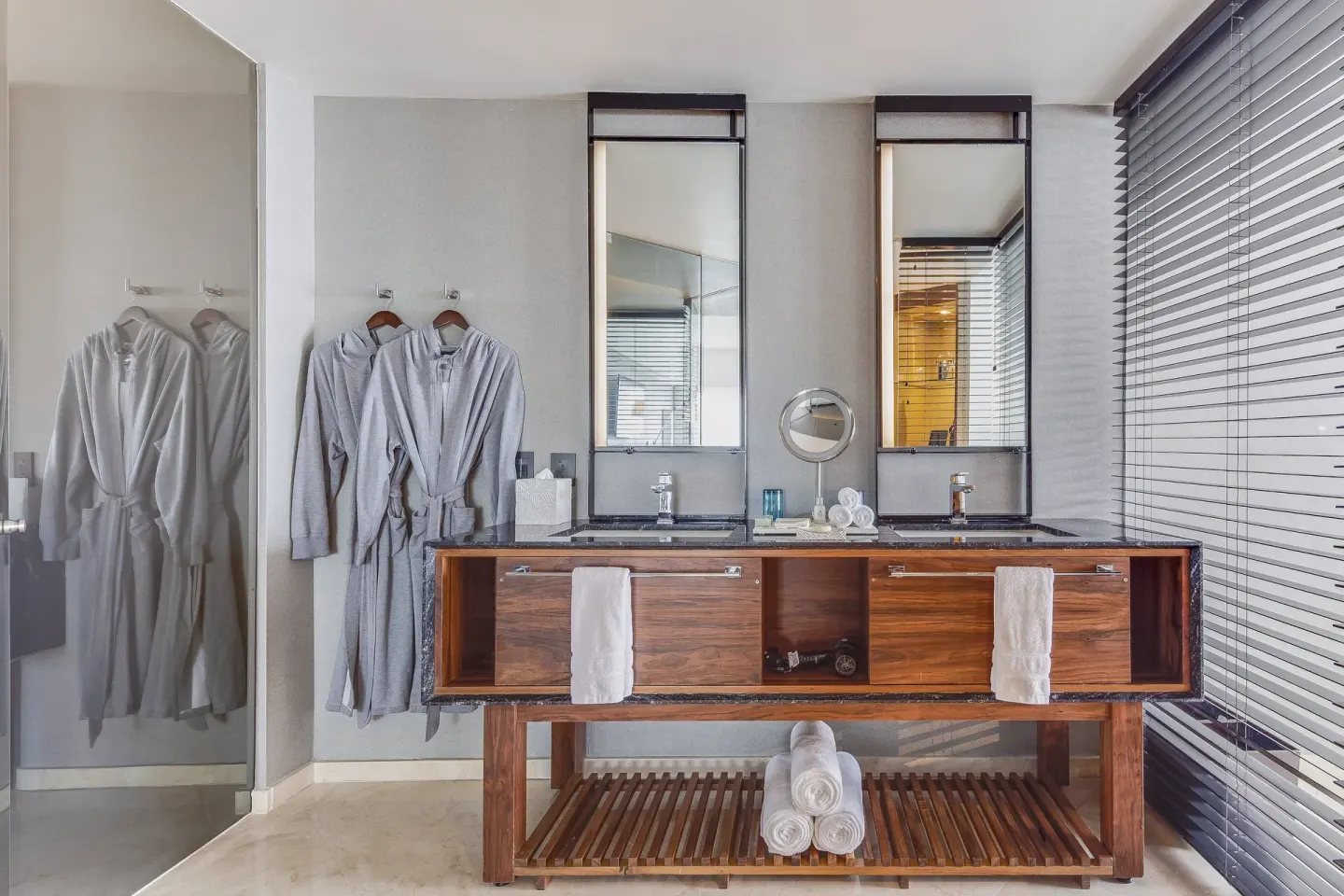 Double vanity with robes and towels in a guest bathroom at Live Aqua Cancun.