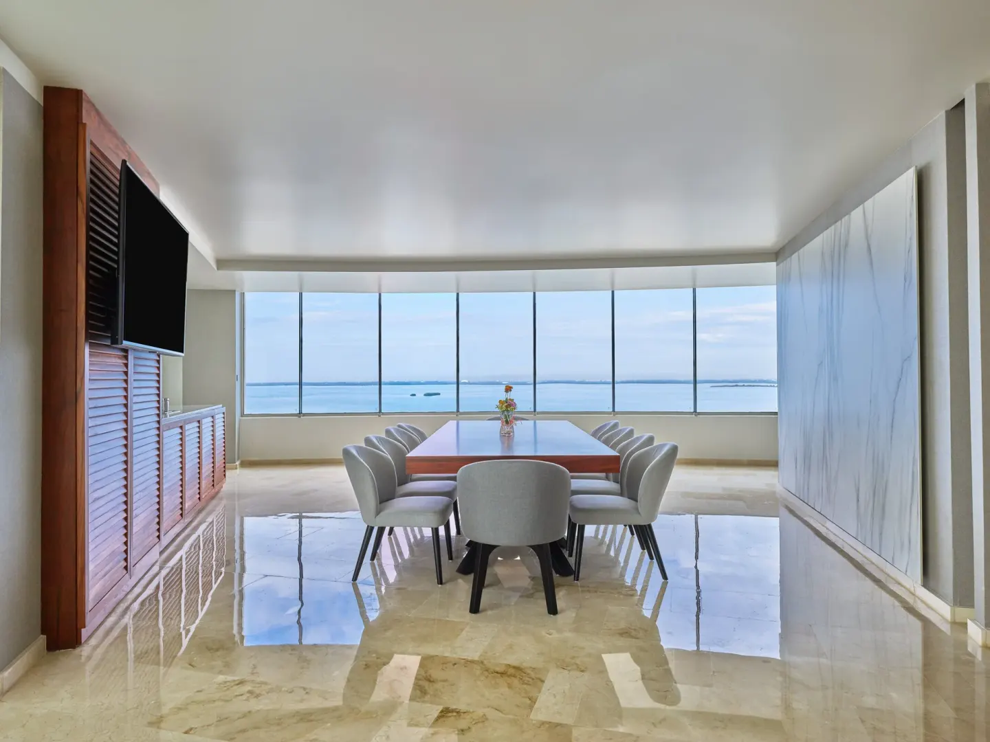 Ocean-view dining table in a bright suite at Live Aqua Cancun.
