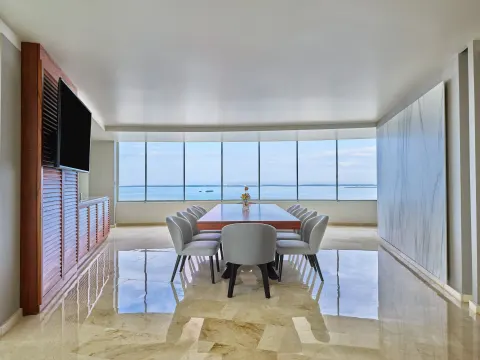 Ocean-view dining table in a bright suite at Live Aqua Cancun.