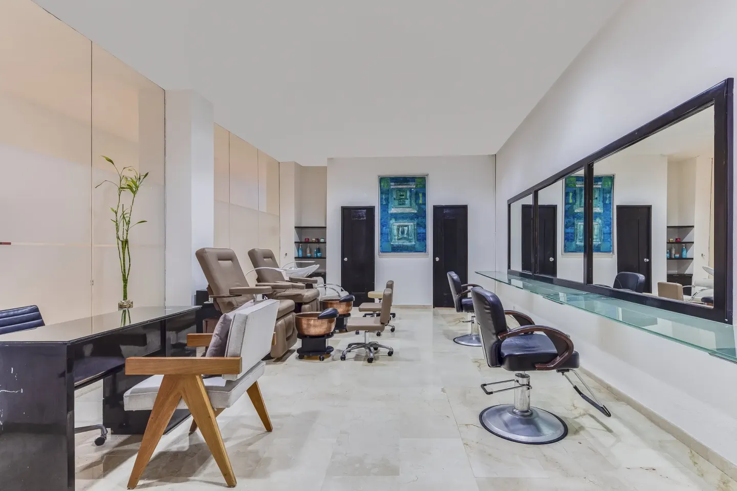 Salon space with styling chairs, mirrors, and pedicure stations at Live Aqua Cancun.