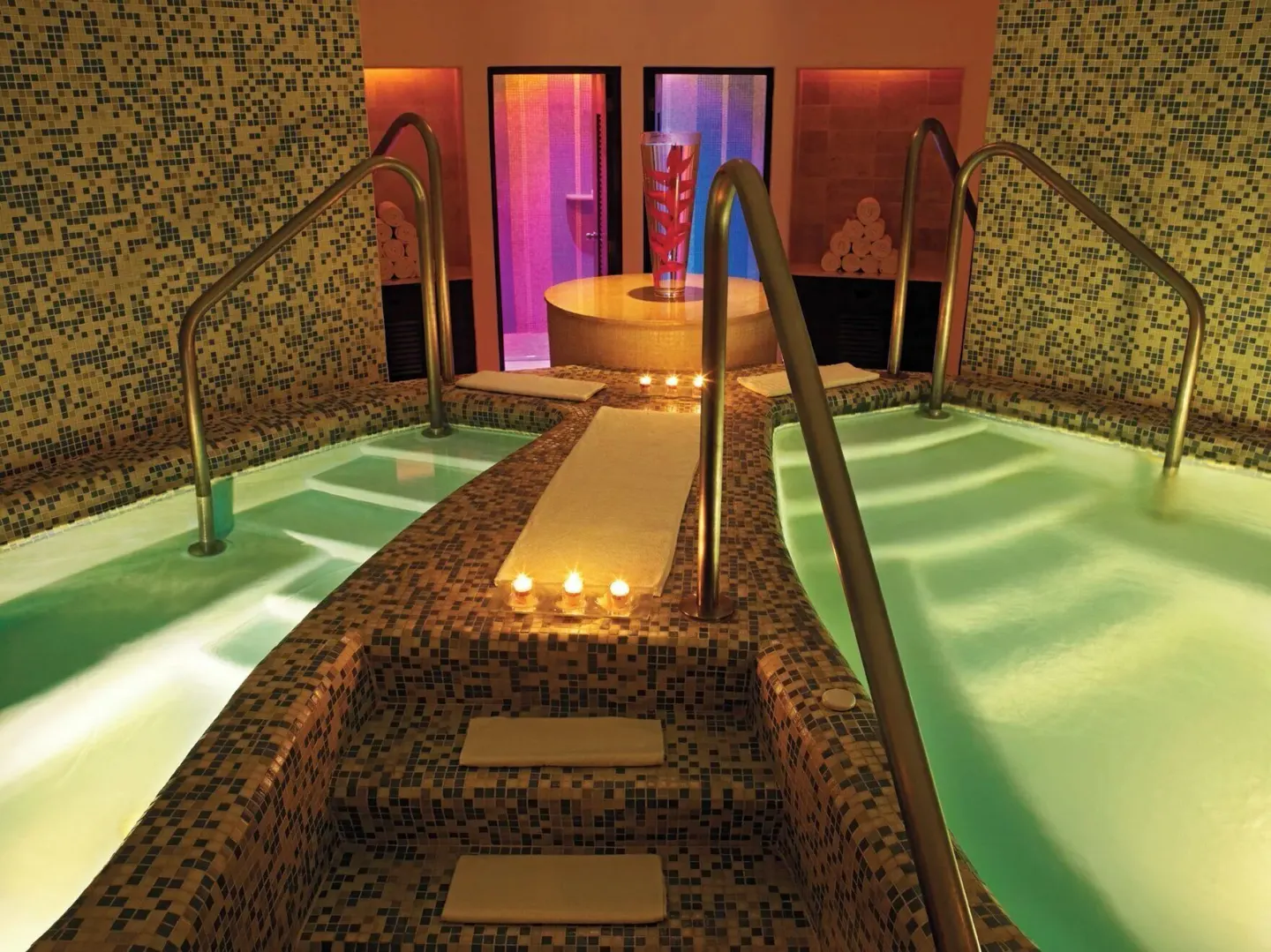 Spa hydrotherapy pools with mosaic tile and candles at Live Aqua Cancun.
