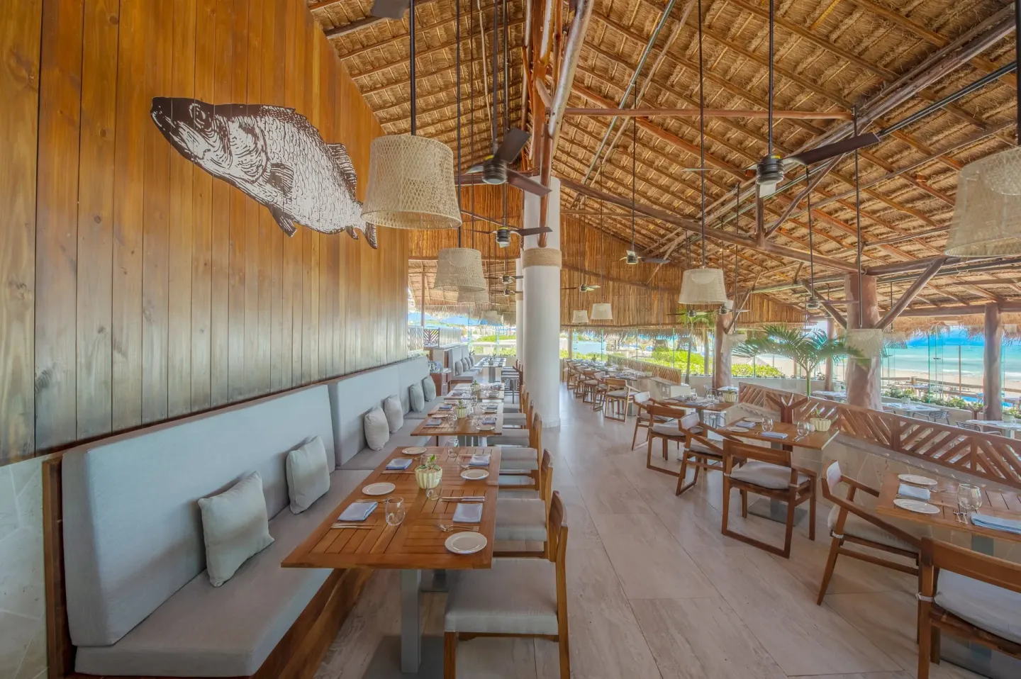 Seafood restaurant dining room with fish wall art at Live Aqua Cancun.