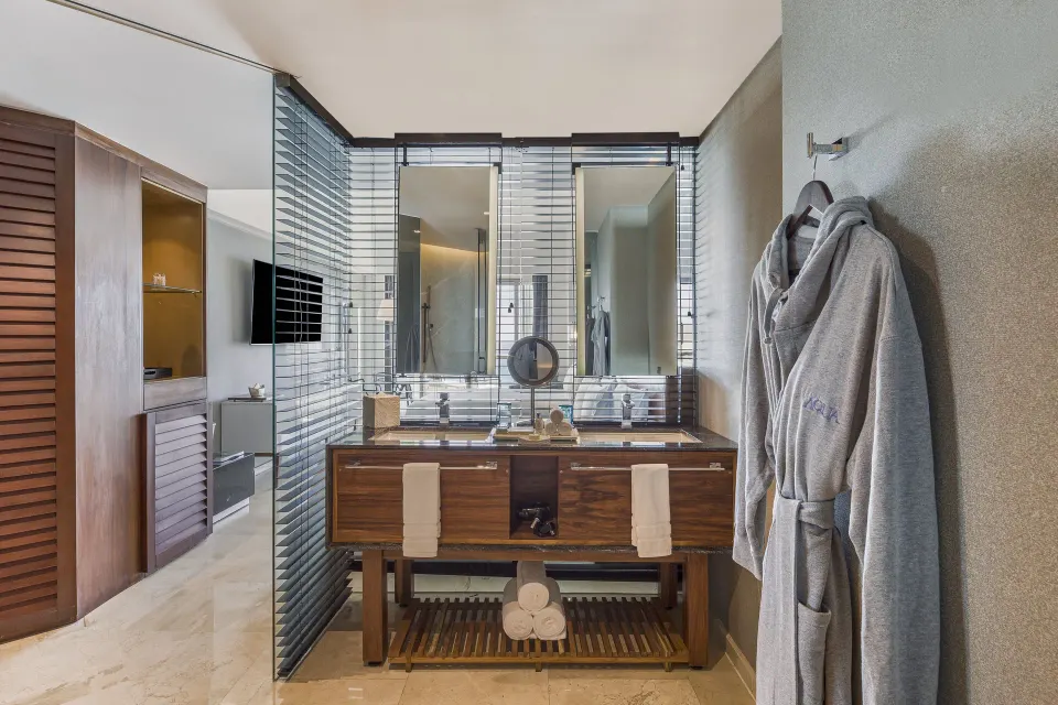 Premium Room bathroom vanity with robes and mirrors at Live Aqua Cancun.