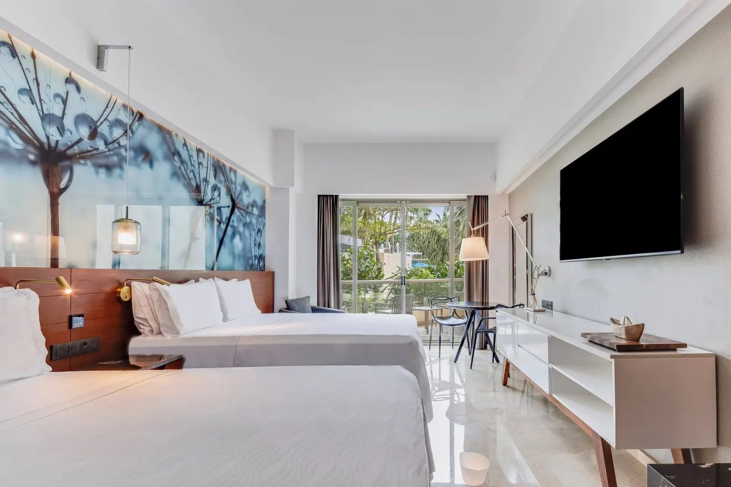 Premium Room with two beds, blue floral wall art, and balcony at Live Aqua Cancun.