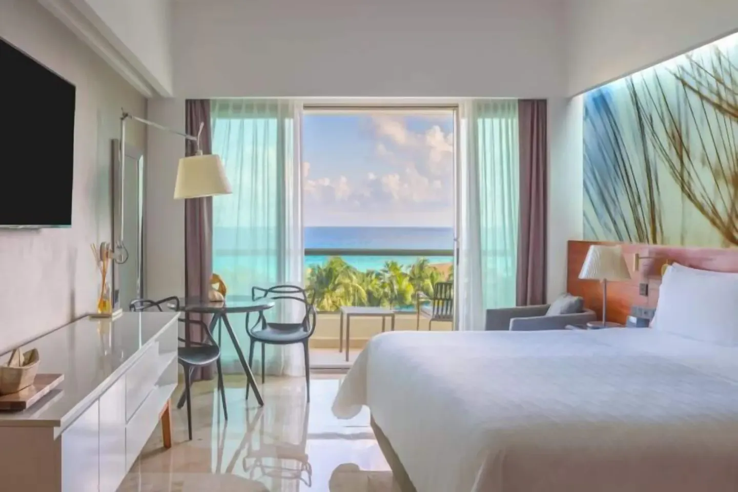 Oceanfront premium room with king bed and balcony view at Live Aqua Cancun.