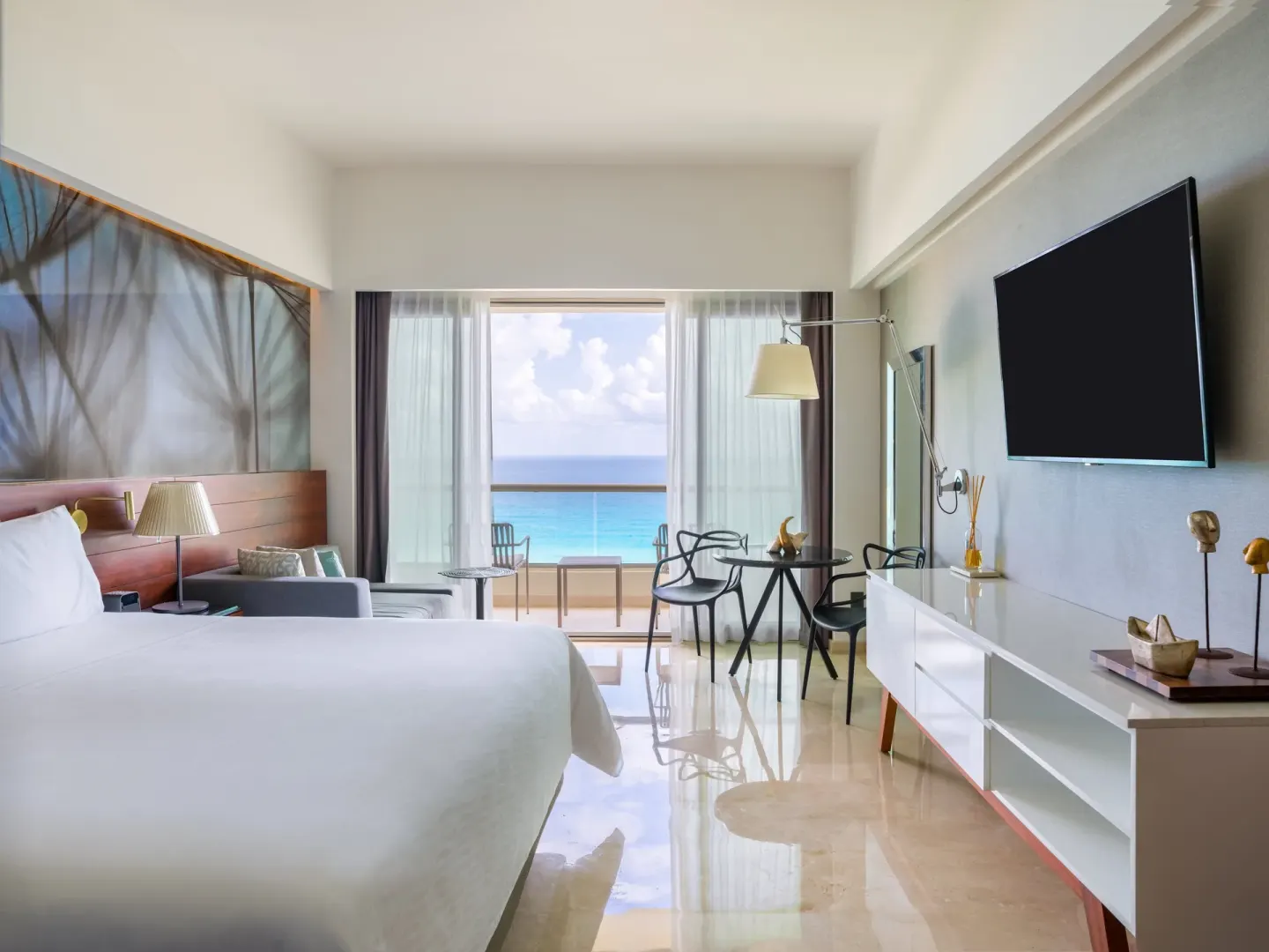 Oceanfront premium room with one visible bed and balcony seating at Live Aqua Cancun.