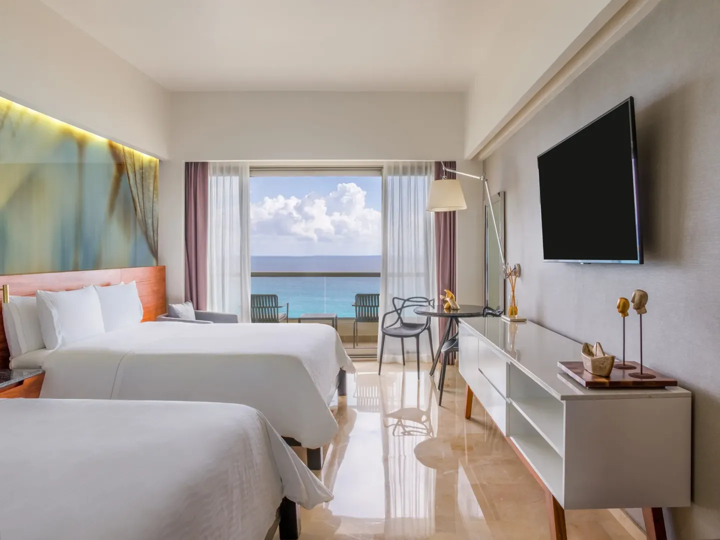 Two-bed premium oceanfront room with balcony chairs at Live Aqua Cancun.